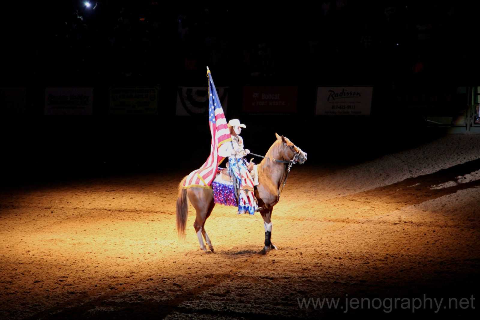 Cowgirl with American flag at the Fort Worth rodeo