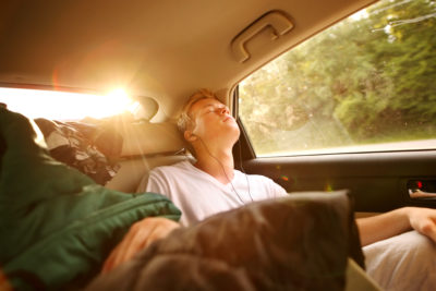 teen sleeping in car via Shutterstock